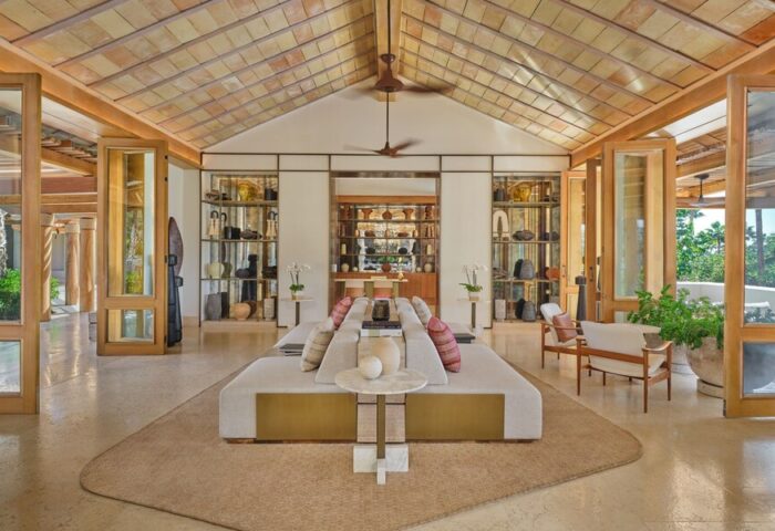 Interior of The St. Regis Punta Mita Resort, a gay-friendly hotel. Open space with seating, shelves, and a high ceiling.