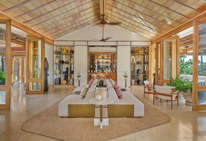Interior of The St. Regis Punta Mita Resort, a gay-friendly hotel. Open space with seating, shelves, and a high ceiling.