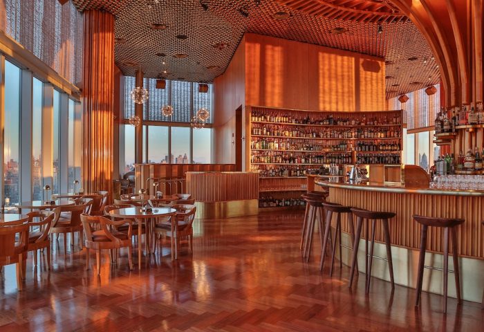 Bar interior at The Standard, High Line, New York. Gay-friendly hotel with city views, bar stools, and a fully stocked bar.
