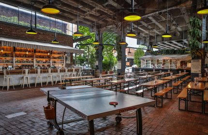 The Standard High Line New York gay-friendly hotel beer garden with a ping pong table, bar, and communal tables. A great place to socialize.