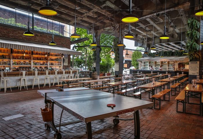 The Standard High Line New York gay-friendly hotel beer garden with a ping pong table, bar, and communal tables. A great place to socialize.