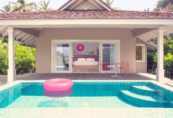 Gay-Friendly Hotel The Standard Huruvalhi Maldives with pool and pink float. Luxury travel for gay men in the Maldives. Gay travel goals.