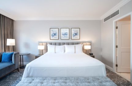 Gay-friendly The Sutton Place Hotel Vancouver bedroom. King bed, couch, and ensuite. Luxury stay for gay travelers in Vancouver, Canada.