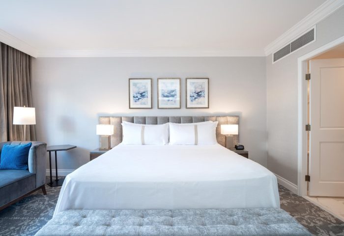 Gay-friendly The Sutton Place Hotel Vancouver bedroom. King bed, couch, and ensuite. Luxury stay for gay travelers in Vancouver, Canada.