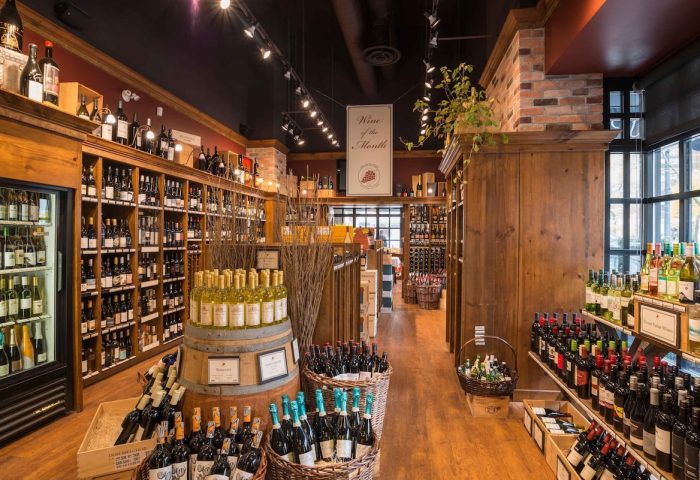 Wine cellar at The Sutton Place Hotel Vancouver, a gay-friendly hotel. Bottles are displayed on shelves and in baskets.