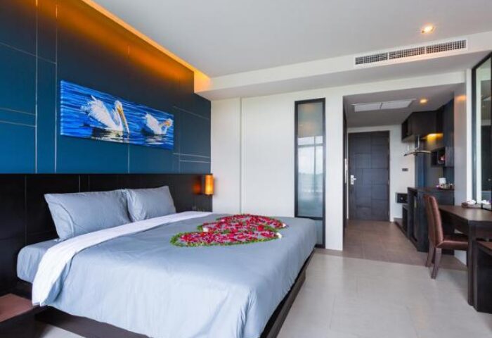 The Tama Hotel bedroom. Gay-friendly hotel room with a bed decorated with flower petals. Modern interior design, perfect for gay travelers.