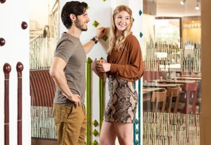 Gay-friendly The Three Corners Hotel Art Superior: A man and woman in a stylish hotel lobby with artistic design elements.