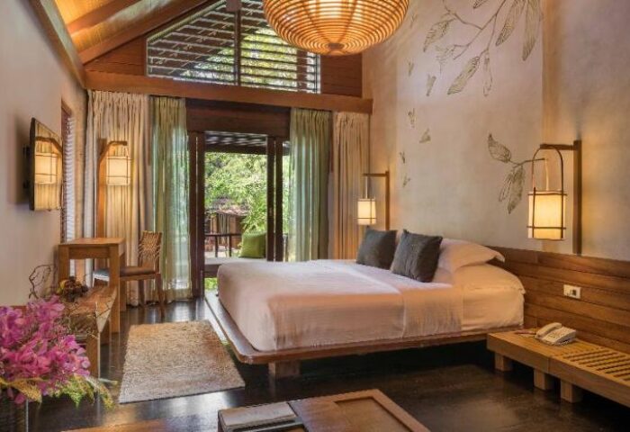 Tubkaak Krabi Boutique Resort room. Gay-friendly hotel with a king bed, balcony, and nature views. Ideal for gay men's travel in Krabi.