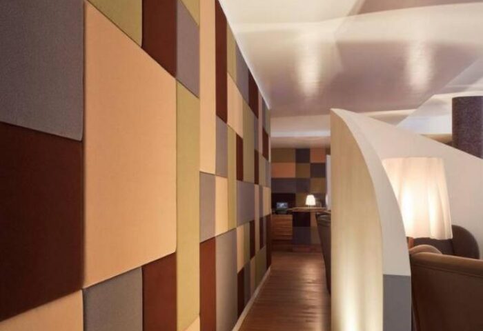 The Weinmeister Berlin-Mitte Adults Only hotel interior. Modern design with a colorful geometric wall, and a bright, stylish lounge area.