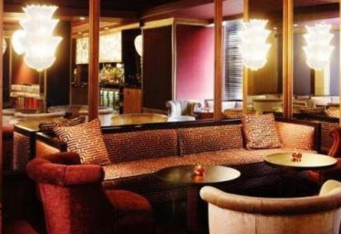 Luxurious lounge area at The Westbury Hotel, a gay-friendly hotel. Stylish seating, mirrored walls, and elegant lighting. Perfect for gay travel.