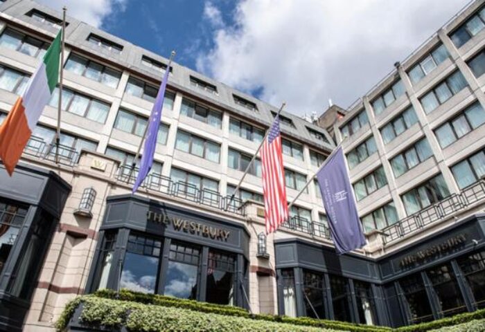 The Westbury Hotel facade with flags. A gay-friendly hotel in Dublin, Ireland, offering luxury accommodations and a welcoming atmosphere for LGBTQ+ travelers.