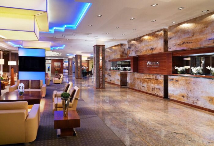 The Westin Grand Frankfurt lobby. Gay-friendly hotel with modern design, seating area, and reception. Upscale travel for gay men in Frankfurt.
