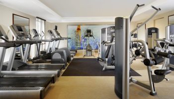 Gym at The Westin Grand Frankfurt, a gay-friendly hotel. Treadmills, elliptical machines, and weight machines. Fitness center, workout.