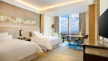 The Westin Jakarta gay-friendly hotel room. Two beds, desk, city view. Modern design. Luxury travel for gay men.