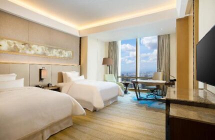 The Westin Jakarta gay-friendly hotel room. Two beds, desk, city view. Modern design. Luxury travel for gay men.