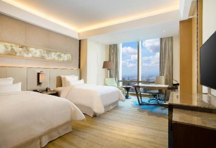 The Westin Jakarta gay-friendly hotel room. Two beds, desk, city view. Modern design. Luxury travel for gay men.