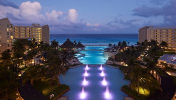 The Westin Lagunamar Ocean Resort Villas & Spa Cancun at dusk. Gay-friendly hotel with pools, beach, and ocean view.