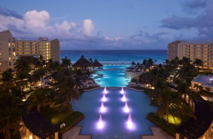 The Westin Lagunamar Ocean Resort Villas & Spa Cancun at dusk. Gay-friendly hotel with pools, beach, and ocean view.