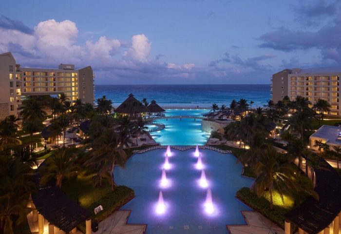 The Westin Lagunamar Ocean Resort Villas & Spa Cancun at dusk. Gay-friendly hotel with pools, beach, and ocean view.
