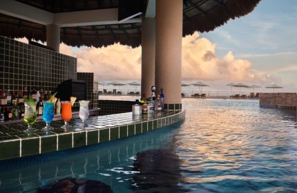 Swim-up bar at The Westin Lagunamar Ocean Resort Villas & Spa Cancun. Cocktails, pool, ocean view. Gay-friendly hotel in Cancun, Mexico.