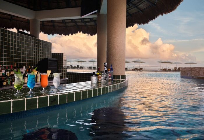 Swim-up bar at The Westin Lagunamar Ocean Resort Villas & Spa Cancun. Cocktails, pool, ocean view. Gay-friendly hotel in Cancun, Mexico.