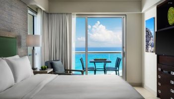 Bedroom at The Westin Lagunamar Ocean Resort Villas & Spa Cancun. Balcony with ocean view. Gay-friendly hotel in Cancun.