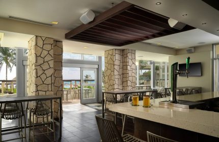Bar view at The Westin Lagunamar Ocean Resort Villas & Spa Cancun. Gay-friendly hotel with ocean view. Mugs of beer on the bar top.