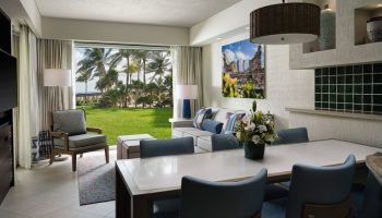 The Westin Lagunamar Ocean Resort Villas & Spa Cancun suite. Gay-friendly hotel with ocean view, dining table, and living area.