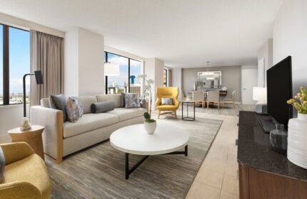 The Westin Long Beach gay-friendly hotel suite: living area with sofa, chairs, table, city view. Ideal for LGBT travelers' comfort.
