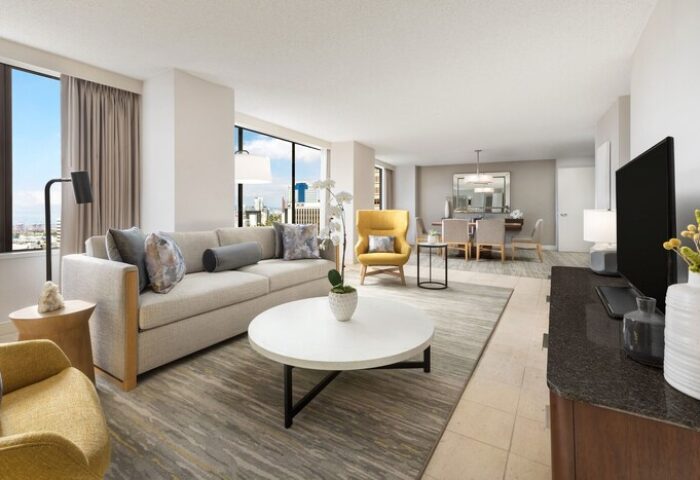 The Westin Long Beach gay-friendly hotel suite: living area with sofa, chairs, table, city view. Ideal for LGBT travelers' comfort.