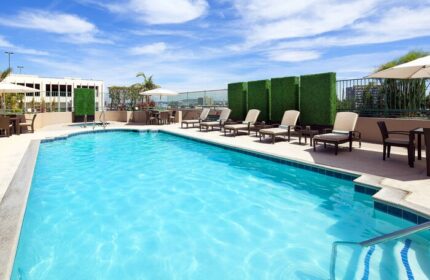 The Westin Long Beach gay-friendly hotel pool. Outdoor pool with lounge chairs, tables, & umbrellas. Perfect for gay men's travel.