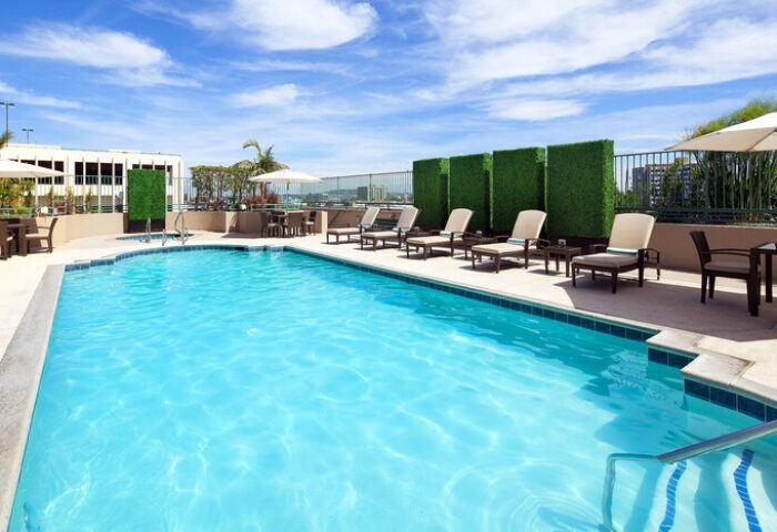 The Westin Long Beach gay-friendly hotel pool. Outdoor pool with lounge chairs, tables, & umbrellas. Perfect for gay men's travel.