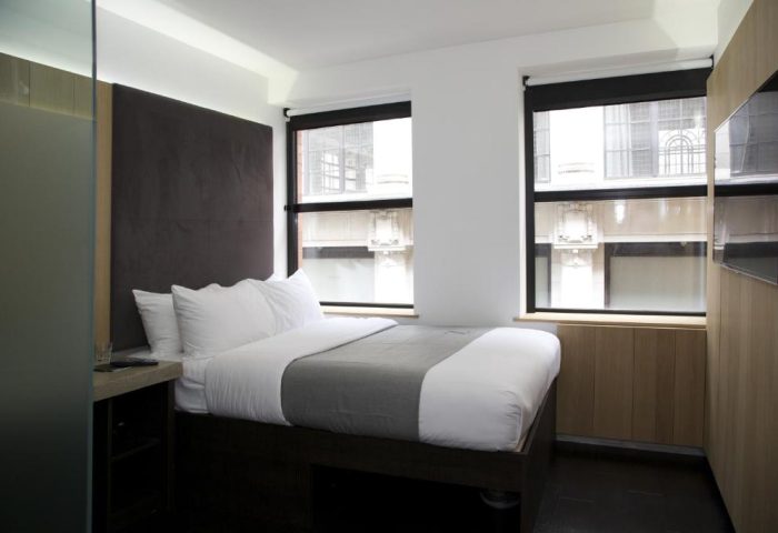 Gay-Friendly Hotel The Z Hotel City: Minimalist room with double bed, large headboard, and two windows. Modern design, ideal for gay travelers.