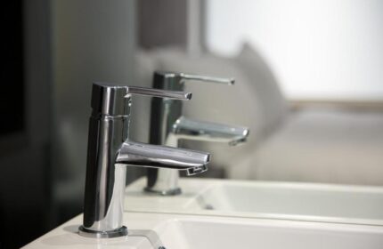 Chrome faucet detail in bathroom of gay-friendly The Z Hotel City. Modern design, clean lines, and bright lighting for discerning travelers.