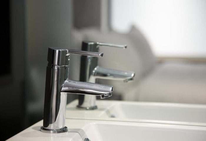Chrome faucet detail in bathroom of gay-friendly The Z Hotel City. Modern design, clean lines, and bright lighting for discerning travelers.
