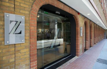 The Z Hotel Piccadilly entrance. Gay-friendly hotel with brick facade and glass doors. Z Hotels logo visible. A great choice for gay travel.