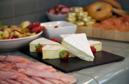 Buffet at The Z Hotel Piccadilly, a gay-friendly hotel. Brie, strawberries, ham, and bagels offer a delicious dining experience.