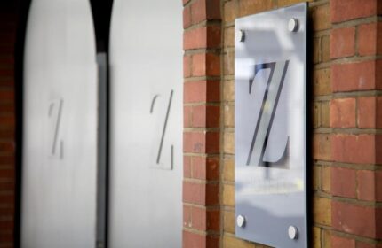 The Z Hotel Piccadilly entrance. Gay-friendly hotel sign on a brick wall. The Z Hotels logo is visible. Gay travel advice in London.