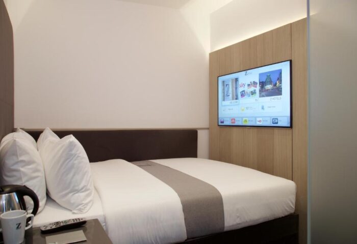 The Z Hotel Shoreditch room. Modern, gay-friendly design. Bed with white linens, TV, and minimalist decor. Ideal for gay travel in Shoreditch.