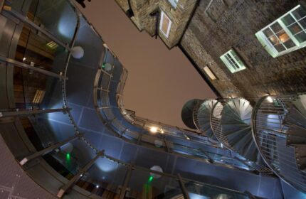 The Z Hotel Soho's unique architecture. View looking up at spiral staircase and glass walkway. Gay-friendly hotel in London.
