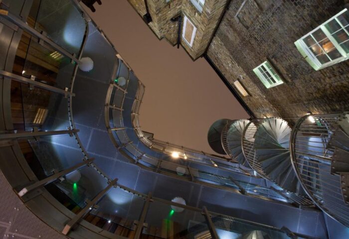 The Z Hotel Soho's unique architecture. View looking up at spiral staircase and glass walkway. Gay-friendly hotel in London.