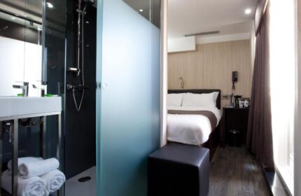 The Z Hotel Soho room. Modern bathroom with shower and frosted glass next to the bed. Gay-friendly hotel in London's Soho.