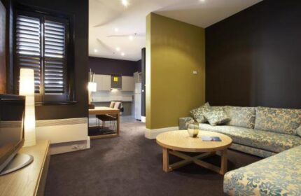 Tolarno Hotel room. Gay-friendly hotel with a living area, table, and kitchen. A great place to stay for gay men visiting.