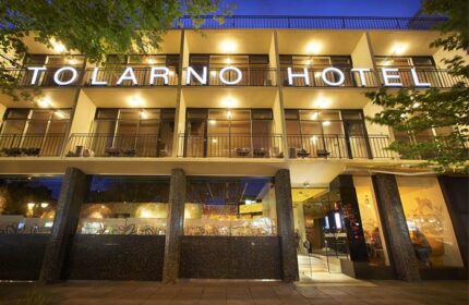 Facade of Tolarno Hotel, a gay-friendly hotel. The building has balconies and a sign with the hotel's name. Gay travel advice.