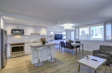 Town Inn Suites gay-friendly hotel room. Modern kitchen, dining area, and living space. City view. Ideal for gay travel.