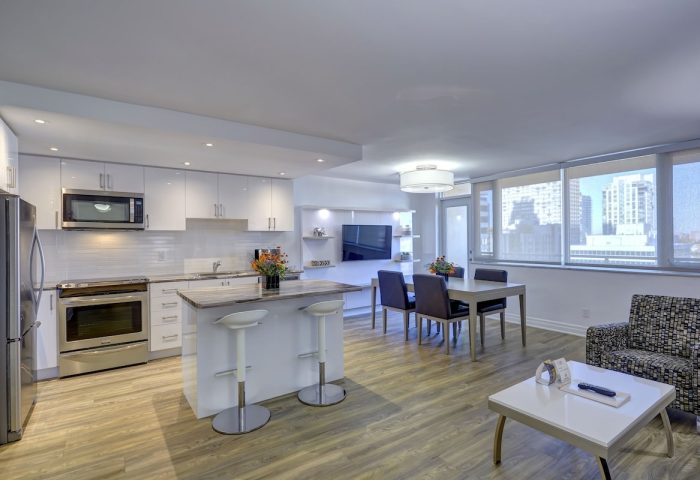 Town Inn Suites gay-friendly hotel room. Modern kitchen, dining area, and living space. City view. Ideal for gay travel.