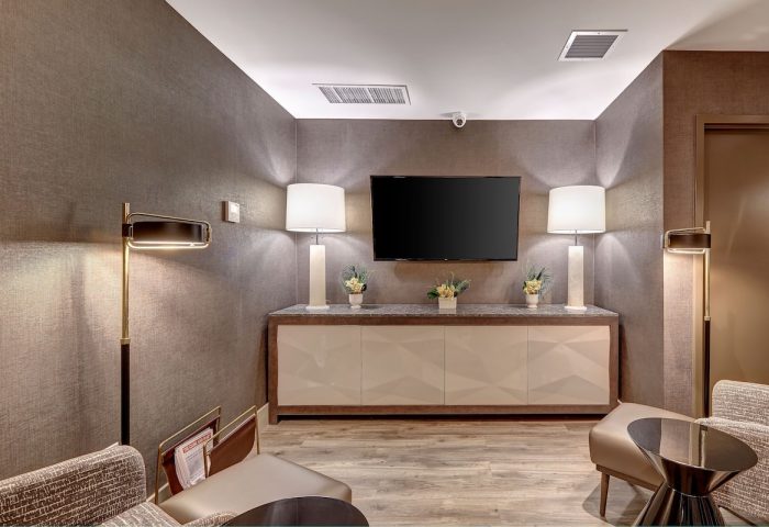 Town Inn Suites, a gay-friendly hotel. Modern hotel lounge area with TV, lamps, seating, and contemporary design. Ideal for gay travelers.