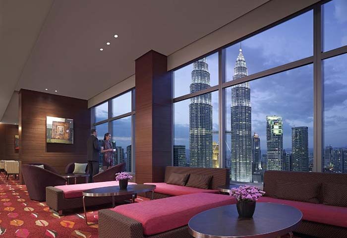 Gay-friendly Traders Hotel Kuala Lumpur lounge area. View of the Petronas Towers. Ideal for gay travelers seeking luxury in Kuala Lumpur.