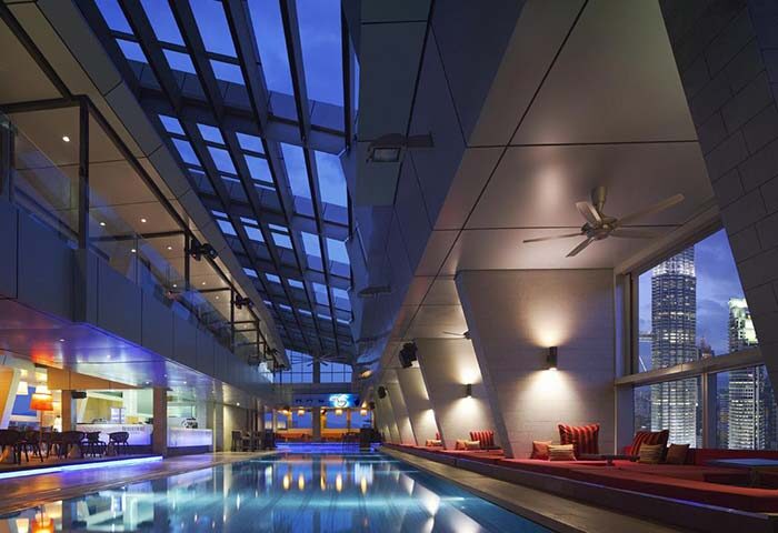 Gay-friendly Traders Hotel Kuala Lumpur pool. Modern design, city view. Ideal for gay travelers seeking luxury in Kuala Lumpur.