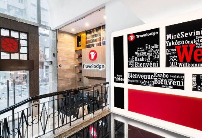 Travelodge Central Hollywood Road lobby. Gay-friendly hotel with welcome messages in different languages. Modern interior design. Travel advice for gay men.